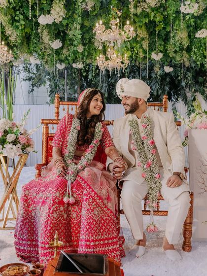 A happy portrait of the newlyweds. The bride's makeup is fresh and radiant, complementing her joyful smile and the beautiful decor.