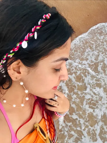A serene moment by the sea in Goa. This photo gives a closer look at my beach hairstyle, featuring a braided shell hairband that adds a bohemian touch.