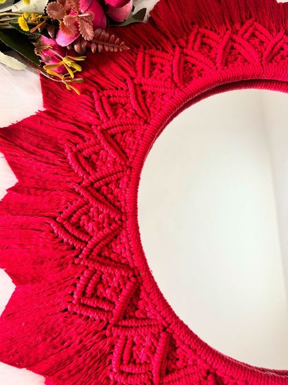 A detailed shot of the macrame work around the edge of the red mirror mandala. Every knot is tied by hand to create this beautiful pattern.