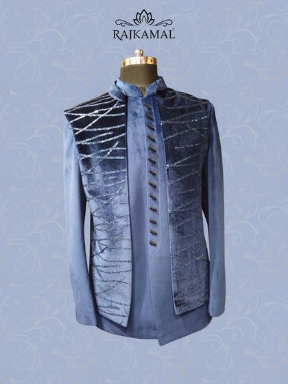 A midnight blue layered jacket with a velvet texture and gradient sequin work. This piece is perfect for a baraati who wants to dress to impress.