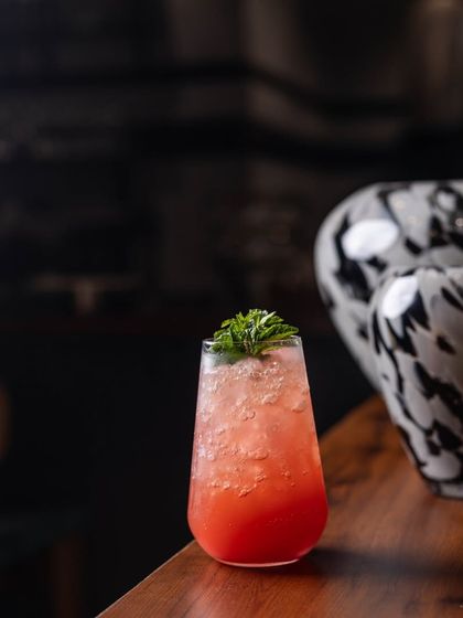 Weekends call for some good cocktails. This vibrant red drink with a fresh garnish is ready to be enjoyed.