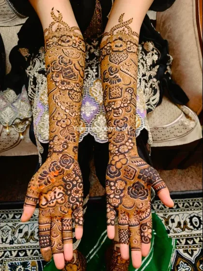 A detailed bridal design with the groom's name, Junaid, incorporated into the artwork.
