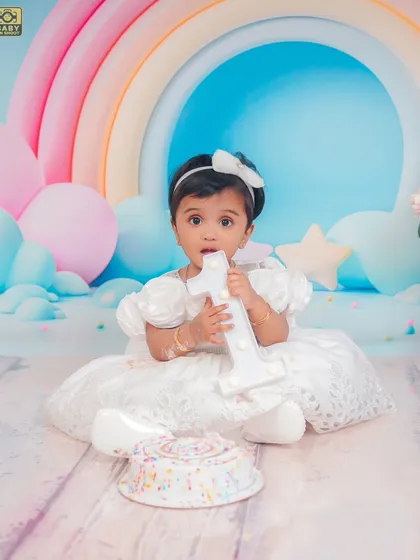 A fun shot with the light-up number one. Cake smash sessions are a fantastic way to end a first birthday photoshoot.