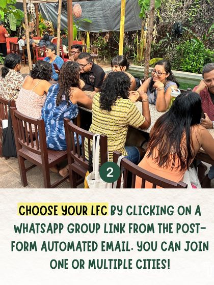 A group of people enjoying conversation around a table at a Local Food Club meetup.