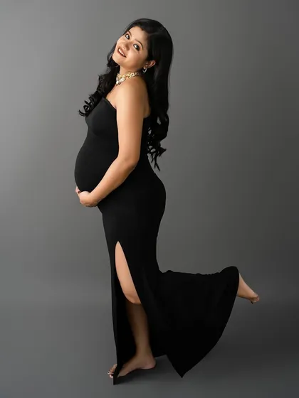 A playful and happy pose in a glamorous black gown. This shot is full of movement and joy, celebrating the excitement of this special time.