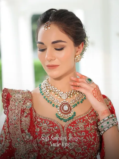 Soft smokey eyes paired with nude lips are a classic combination for a reason. It's a versatile and elegant look that defines the eyes without overpowering the bride's natural beauty.