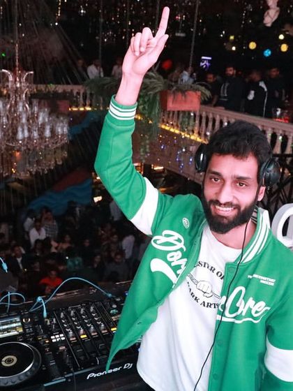 All smiles at Bombay Adda, with the beautiful chandelier in the background.