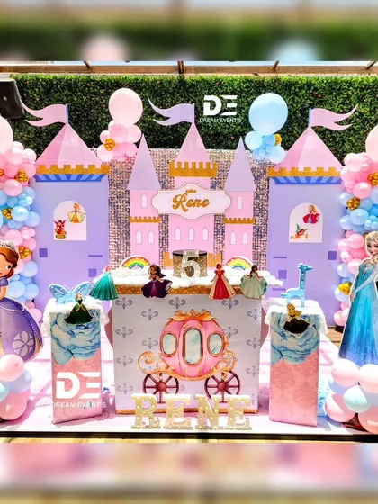 Every princess deserves a castle. This fairytale setup features a grand castle backdrop with Elsa and Sofia the First, a royal carriage, and a beautiful pink and blue balloon arrangement, creating a truly royal celebration for your little princess.