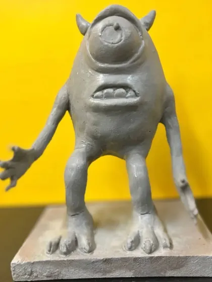 Another angle of the Mike Wazowski sculpture, highlighting the character's limbs and stance. Our figurative sculpting course covers the fundamentals of anatomy and proportion to create believable figures.