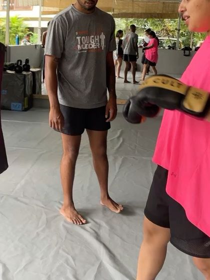 A member getting some instruction from a coach during a full body workout.