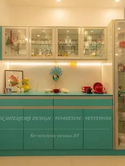 This vibrant turquoise crockery unit adds a pop of color to the dining area. The design features glass cabinets for display and ample closed storage below.