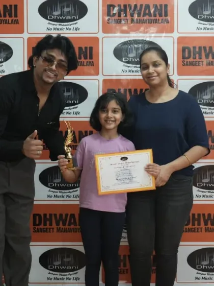 A young achiever celebrates her award with her parent and teacher. We foster a strong community where families are part of the learning journey, creating a supportive environment for both kids and adults.