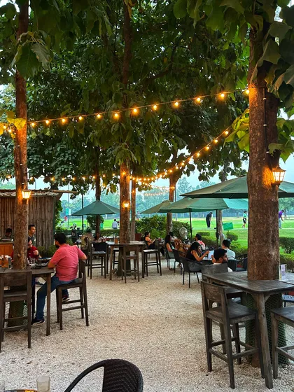 The cafe patio at night, with warm string lights creating a cozy and intimate atmosphere.