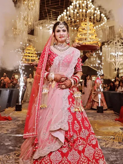 A grand bridal entry shot, with the bride walking through a cloud of smoke and flanked by pyrotechnics.