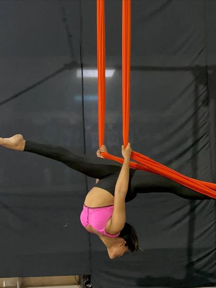 Holding a challenging inverted split requires immense core control and flexibility. This is the kind of advanced skill our students work towards.