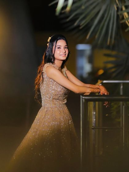 A close-up shot by the railing, her hair and makeup looking perfect.
