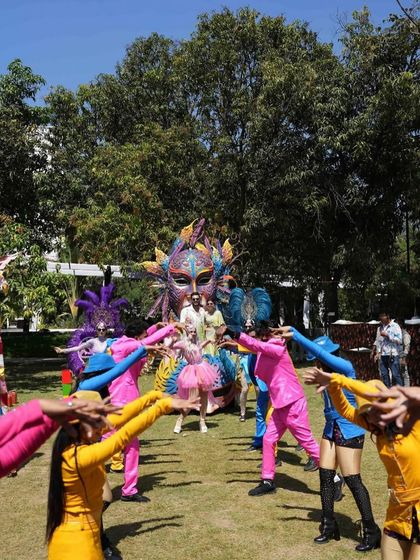 A choreographed dance moment with performers in bright costumes, adding to the high-energy entertainment of the carnival.