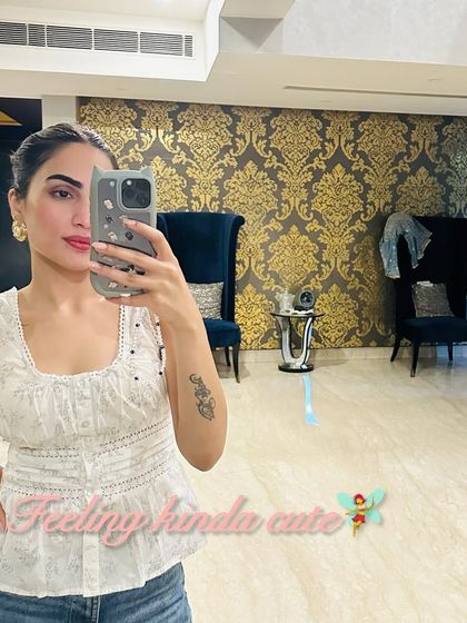 A mirror selfie in a cute white peplum top. This style is great for adding a little flair to a simple jeans-and-top outfit.