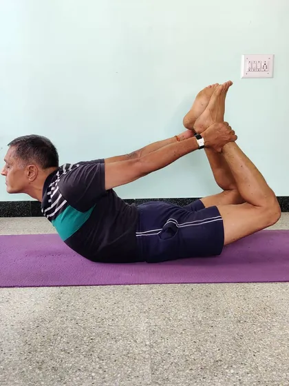 Dhanurasana (Bow Pose). This backbend strengthens the back muscles, opens the chest and shoulders, and improves posture.