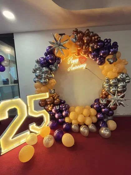 A clear, well-lit photo of the 25th-anniversary ring backdrop.
