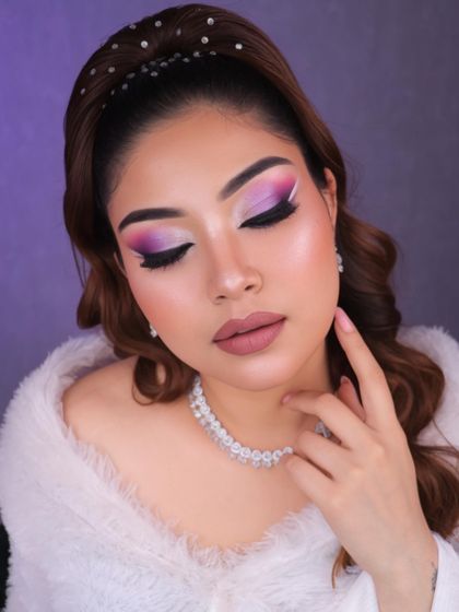 Dive into a world of glam and creativity with this purple and pink graphic eye makeup. The white liner detail adds a futuristic touch, perfect for a creative portfolio.