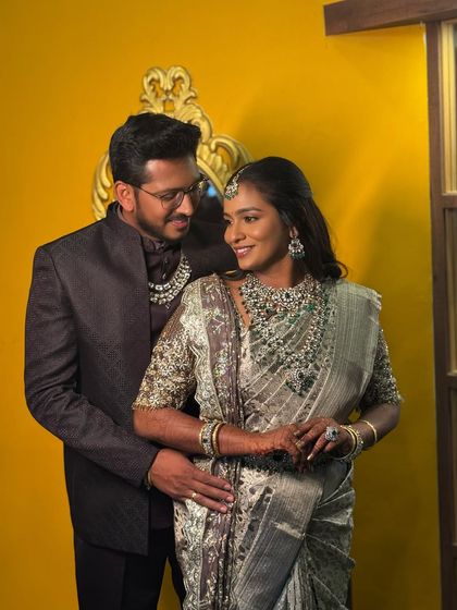 A romantic portrait of Sruthi and her groom. Her makeup looks stunning as she gazes at him, creating a beautiful and memorable wedding photo.