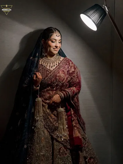 A moody and artistic portrait of the bride, with a single spotlight creating a dramatic effect that highlights her features and her beautiful kalire.