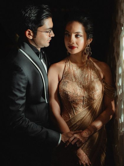 An intimate couple portrait from the reception. The dramatic lighting highlights Tessa's radiant skin and bold red lip, creating a timeless and romantic photograph.