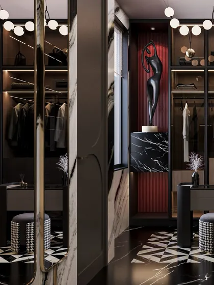 A detail of the wardrobe, where a sculptural art piece is highlighted against a red textured backdrop, adding a surprising pop of color to the monochrome space.