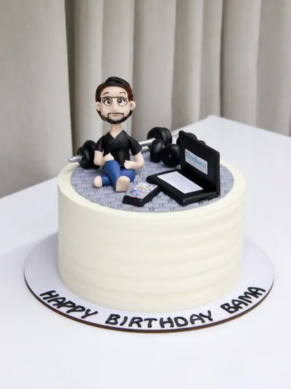 A cake for someone who loves to work hard and play hard. This design features a caricature working on his laptop while also having his workout weights nearby.