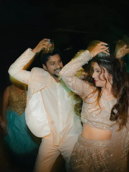 A motion-blurred shot from the dance floor, capturing the energy and movement of the couple as they party at their engagement.
