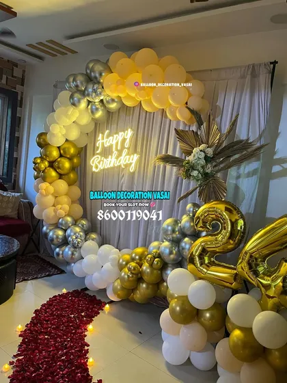 This view shows the gold and silver ring arch with a path of red rose petals leading to it, adding an extra touch of romance to the birthday celebration. Large "24" foil balloons mark the age.