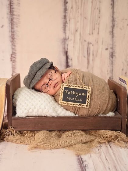 For the little scholar. This nerdy theme with vintage books, a tiny bed, and adorable glasses is a playful and creative way to capture your newborn's personality.