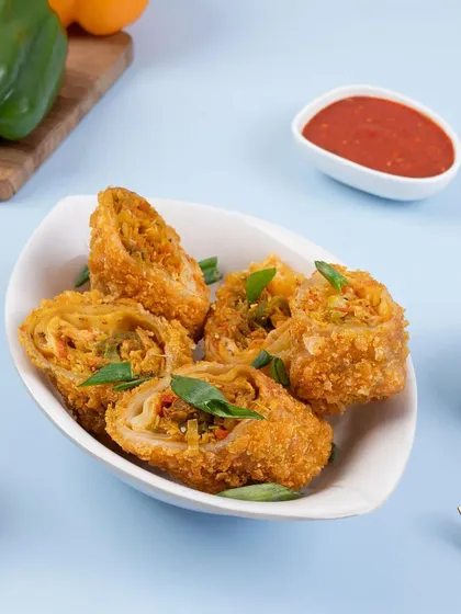Crispy spring rolls cut to show the vegetable filling inside. This is a great way to show customers exactly what they are ordering.