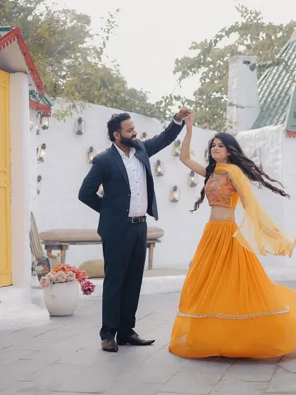 A fun, twirling shot in a studio set that looks like a quaint European street. The bride's flowing lehenga adds beautiful movement to the photo.