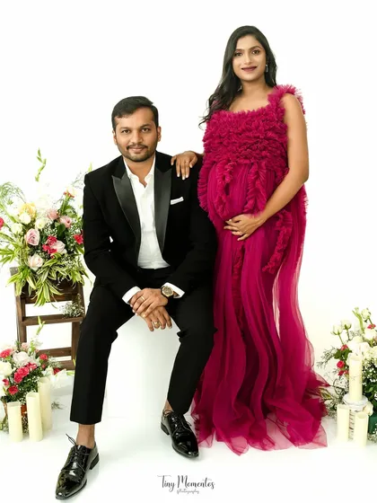 A formal and elegant couple's portrait. The vibrant gown and classic suit create a stunning visual, perfect for celebrating in style.