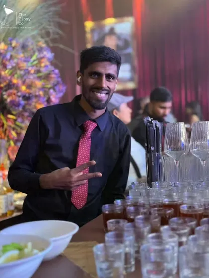 One of our bartenders flashing a peace sign during a busy event. We maintain a positive and energetic attitude, even when the party is in full swing.