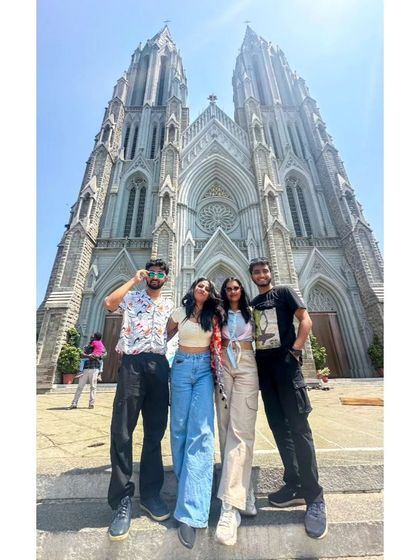 A duplicate of a low-angle shot of our group at St. Philomena's Cathedral, capturing the grand scale of the neo-gothic architecture.