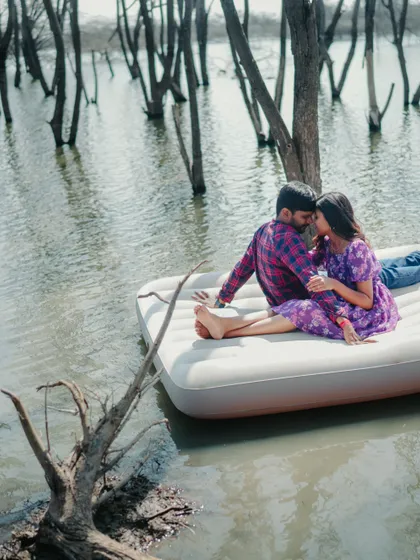 A romantic and intimate moment on the floating mattress. This unique lake photoshoot concept is perfect for adventurous couples.