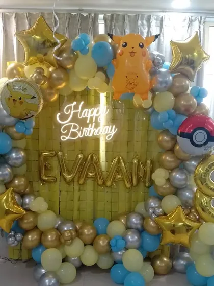 A Pokemon-themed 8th birthday party with a circular balloon arch featuring Pikachu and a Pokeball.