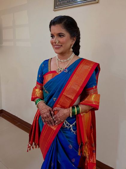 The full look, including a traditional braided hairstyle and a silver waistband (*kamarband*), perfect for the ceremony.