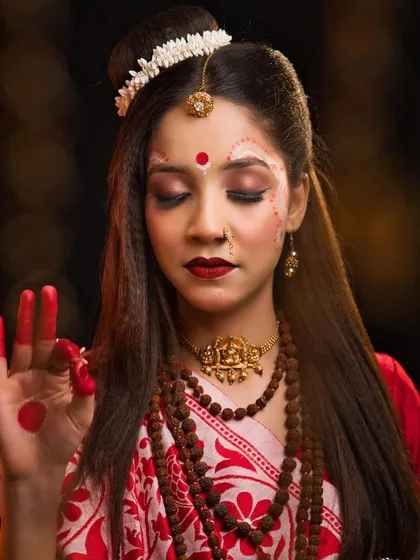 A beautiful closed-eye pose of Maa Brahmacharini, focusing on the traditional white face paint (chandan).