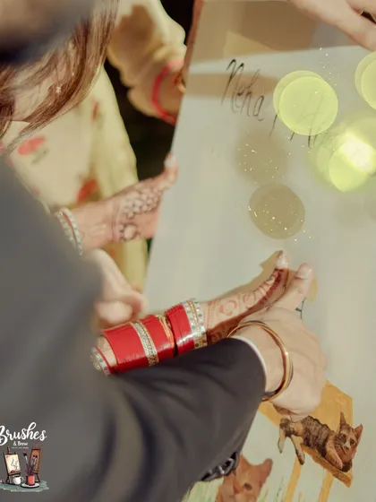 A close-up of the bride's father adding his thumbprint blessing to the canvas. Each print represents a wish of love and happiness for the new couple.