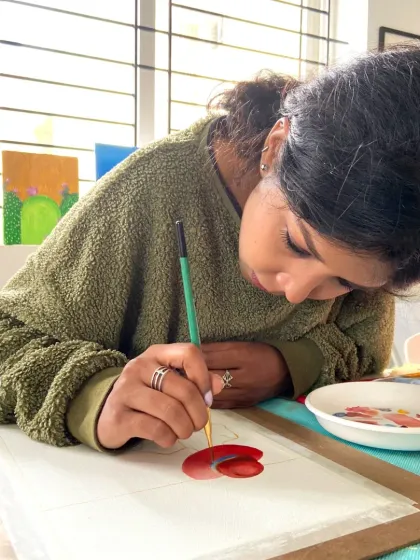 This student is focused on her watercolor painting, learning how to layer colors to create depth and vibrancy.