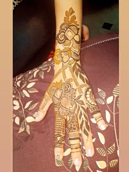 A modern fusion piece that combines geometric shapes with floral elements. The diamond motifs paired with leafy vines give this design a unique and contemporary edge.