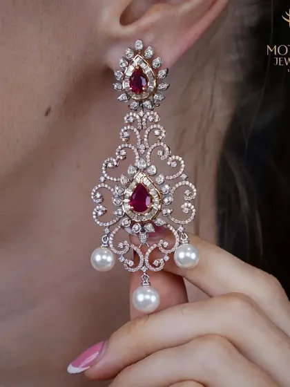 These chandelier earrings are a dance of fire and grace, combining the passion of rubies with the timeless sparkle of diamonds and the soft luster of pearls. I created them to be the centerpiece of an unforgettable evening look.
