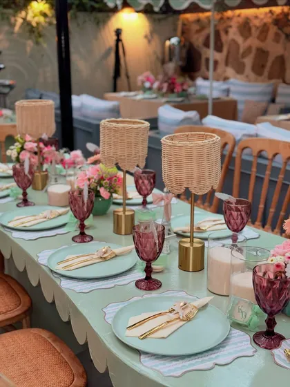 A clean, elegant place setting featuring gold cutlery, a striped placemat, and a delicately tied napkin.