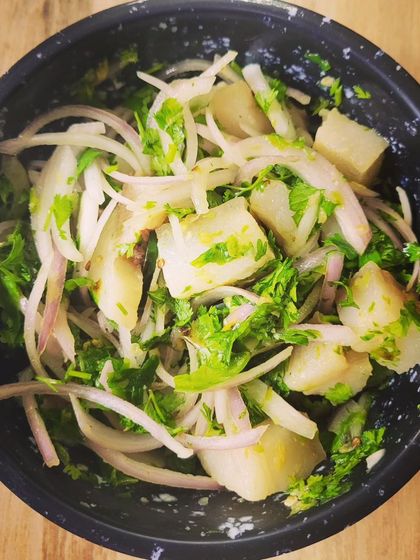 This is Wahan Mosdeng, a refreshing pork salad from Tripura. It's made with boiled pork, thinly sliced onions, and lots of fresh coriander, creating a light yet flavourful dish.