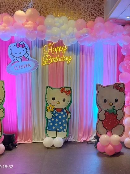 The full stage for the Hello Kitty party, with a curtain backdrop and character cutouts.