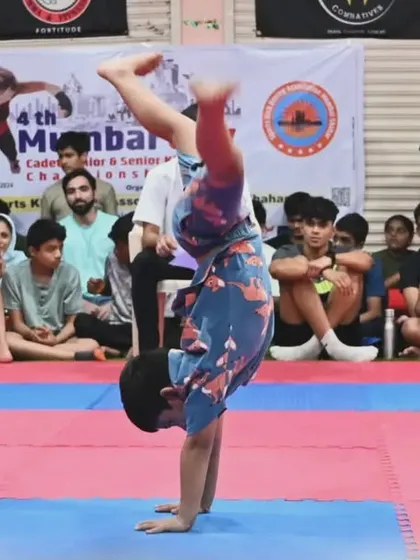 A student performs a creative form during a competition, showcasing the athletic and artistic side of martial arts. We encourage creativity alongside discipline.